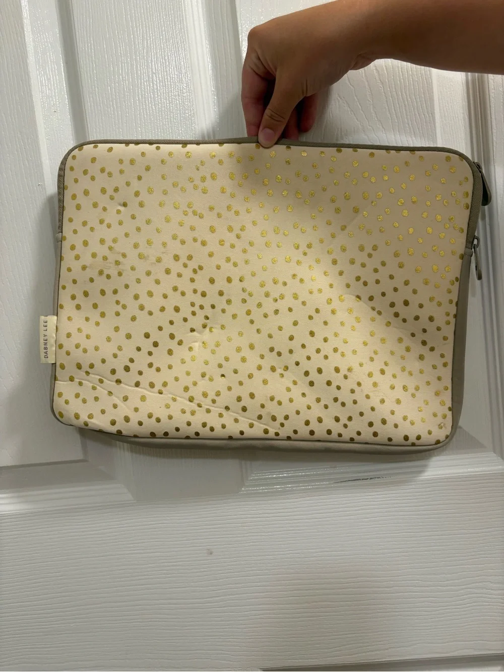 Dabney Lee laptop sleeve in the champagne gold polka dot pattern on cream